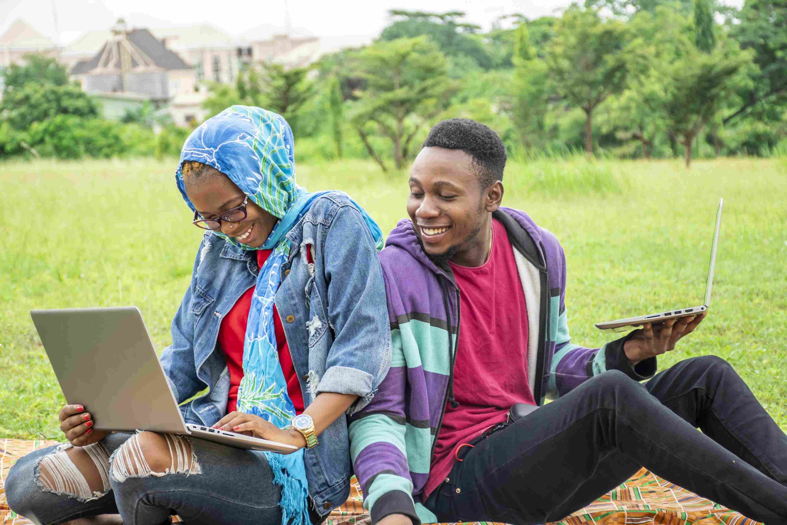young-students-sitting-park-working-college-task-together-their-laptops_11zon